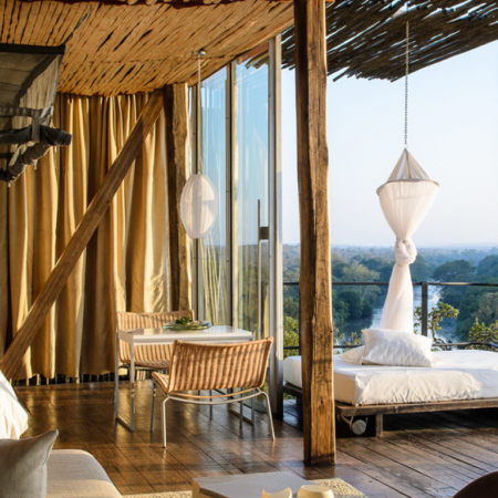 Stay at a beautiful safari lodge overlooking a bustling watering hole